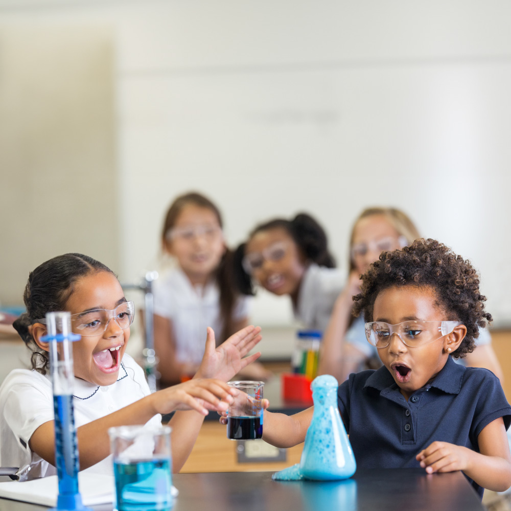 A photo of kids working on a science project together.